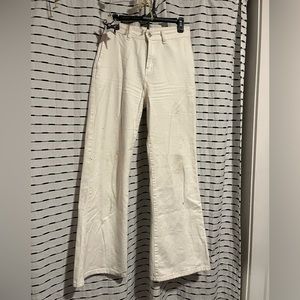 High waisted white flared pants.